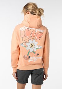 Perzikkleuren hoodie met een grafisch ontwerp van een cartoonbloem en ballonnen op de achterkant, geribde boorden en een trekkoordcapuchon.