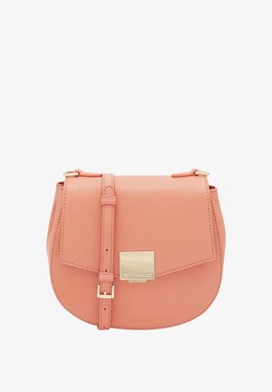 Round peach leather crossbody bag with a flap closure and gold metal hardware. Adjustable strap for varied lengths. Smooth texture.
