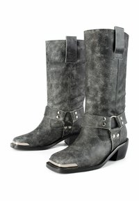 Gray leather cowboy boots with a textured finish, featuring a strap and metal accents, a pointed toe, and a medium block heel.