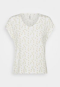 Camiseta blanca de manga corta con cuello en V que presenta un patrón de puntos dorados. Material de algodón suave con un corte relajado y hombros ligeramente caídos.
