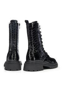 Černé bojové boty z lakované kůže se vzorem krokodýlí kůže, zapínáním na zip, šněrováním vpředu a robustními gumovými podrážkami pro větší odolnost.
