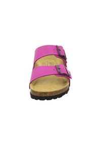Pink two-strap sandal with black buckles, cork footbed, and textured rubber outsole. Features a smooth synthetic upper and flat design.