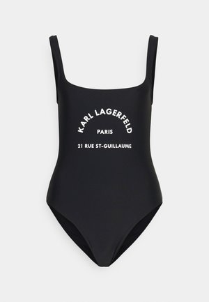 Zwarte badpak met dunne bandjes. Bevat witte bedrukte tekst met "KARL LAGERFELD PARIS 21 RUE ST-GUILLAUME." Gladde textuur.