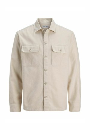 Beige button-up shirt in soft fabric, featuring two chest pockets, long sleeves, and a straight hem. Plain texture with no patterns.