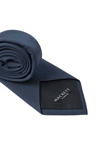 Navy blue silk tie with a smooth texture, featuring a subtle diagonal stripe pattern and a black label with "HACKETT LONDON" text.