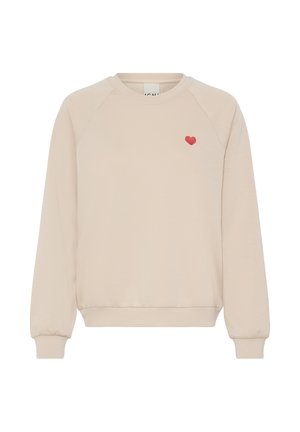 Bēša sporta krekls ar garām raglāna piedurknēm, ribveida manžetēm un apakšmalu. Kreisajā krūtīs neliels sarkans sirds izšuvums. Mīksts, viegls materiāls.