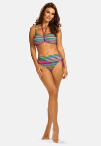 Dwuczęściowy kostium kąpielowy w wielokolorowy, pasiasty wzór w żywych odcieniach. Górna część ma projekt na szyję, a dół związany jest po bokach.