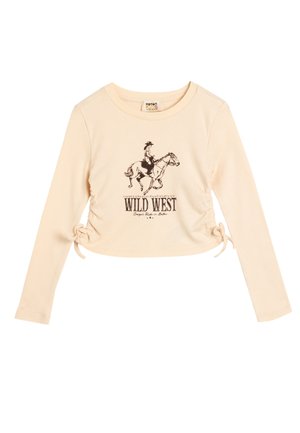 Jasno beżowa, krótka koszula z długim rękawem o prążkowanej strukturze, z czarną grafiką kowboja na koniu i napisem "WILD WEST" pod spodem.