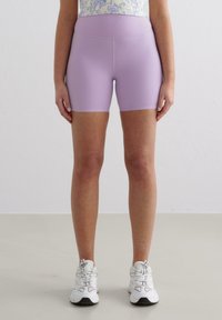 Light purple athletic shorts with a high waistband, made of smooth fabric, feature a fitted silhouette and no visible patterns or accents.