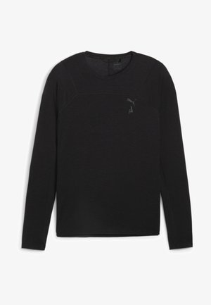 Zwarte lange mouwen t-shirt gemaakt van zachte stof. Heeft een ronde hals, subtiele naaddetails en een klein logo op de borst.