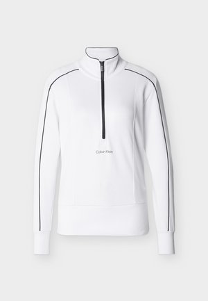 Λευκό πόλο με μακρυμάνικο 1/4 φερμουάρ, με μαύρες ρίγες κατά μήκος των μανικιών και των ώμων, ριμπ μανσέτες και τελείωμα, και λογότυπο Calvin Klein μπροστά.