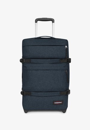 Maleta de tela suave azul oscuro con dos correas de compresión horizontales, un asa telescópica, un bolsillo delantero con cremallera y el logo de Eastpak cerca de la base.