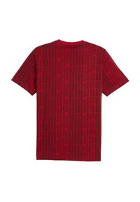 Red short-sleeve t-shirt featuring a grid pattern in darker red, round neckline, and relaxed fit. Made from soft fabric with a smooth texture.