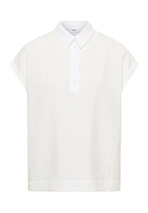 Blouse blanche à manches courtes en tissu texturé, avec patte de boutonnage et col pointu, étiquetée « Cecil » à l'intérieur du col.