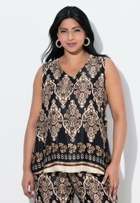 Tunic nera senza maniche a V, con un motivo floreale in oro e crema. Tessuto morbido, design fluido e orlo con un dettaglio a contrasto.