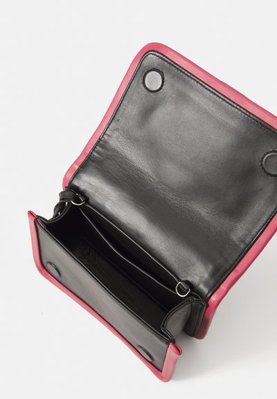 Black leather bag with a bright pink border, featuring two compartments and closure snaps, showcasing a smooth texture and minimalist design.
