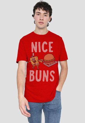 Red cotton t-shirt featuring a cartoon character holding a hamburger with the text "NICE BUNS" in large light-colored letters.