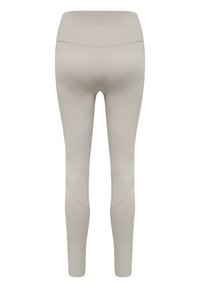 Lichtbeige legging met een gladde, rekbare textuur. Hoge tailleband met een gebogen naaddetail en aansluitende benen die naar de enkels toe toelopen.