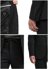 Details eines schwarzen, strukturierten Anzugsjacke und Hose, einschließlich Manschettenknöpfen, Innenetikett und Kordelzug am Hosenbund.
