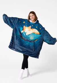 Oversized blue hooded blanket with soft texture, featuring an illustration of a sleeping cat and stars. Front pocket detail included.