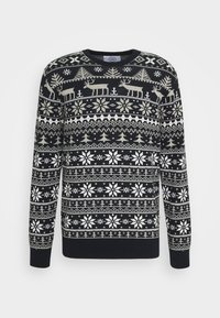 Námořnický modrý svetr s motivem zimních motivů obsahujícím bílé sněhové vločky, soby a stromy. Vyroben z texturovaného pleteného materiálu.