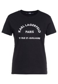 Svart bomulls-t-shirt med vit text: "KARL LAGERFELD PARIS 21 RUE ST-GUILLAUME" i en böjd design. Kort ärm, rundad halsringning.