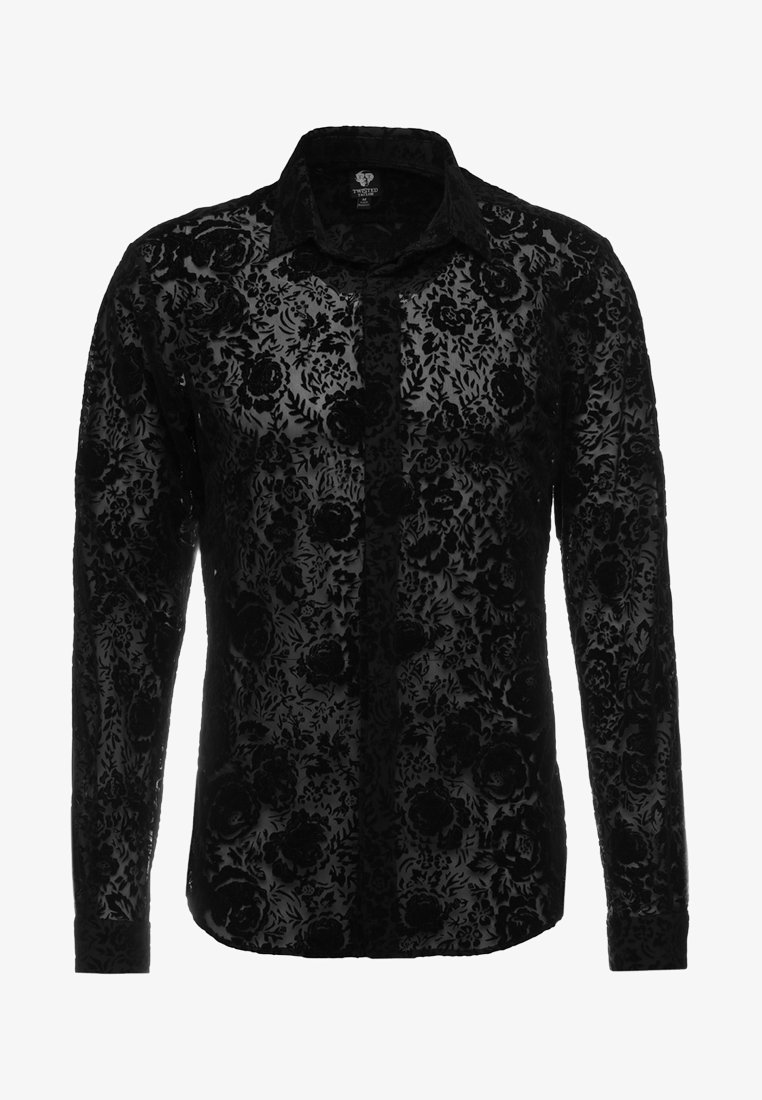 Chemise noire à manches longues avec des boutons, motif floral en velours et col classique, tissu semi-transparent, style masculin.
