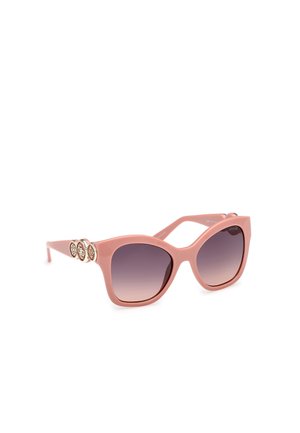 Lunettes de soleil roses en plastique avec des verres dégradés, en forme de cat-eye angulaire, et trois accents circulaires décoratifs sur les tempes.