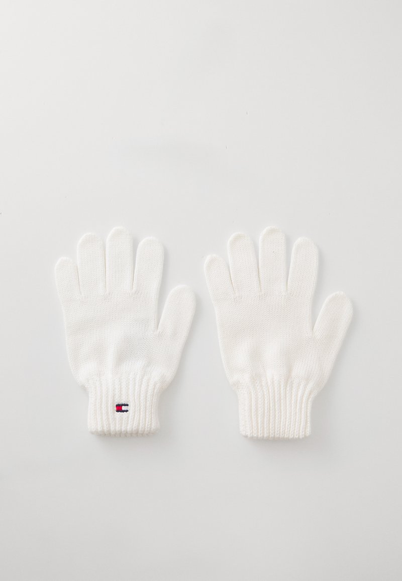 White knitted gloves featuring ribbed cuffs and a small logo with red and blue accents. The design includes five separate finger compartments.