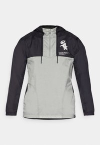 Lightweight hooded jacket featuring a color-block design in black and gray, with a front logo and two side pockets. Smooth texture, adjustable hood.