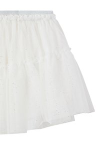 Gonna in tulle bianco con più strati, design arricciato, leggere paillettes sparse e una vita elastica in argento.