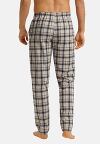 Geruite pyjamabroek in beige, marineblauw en lichtblauw; van katoen; elastische tailleband; rechte snit; geen zichtbare zakken.