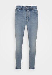 Jeans skinny fit feitos de denim azul claro, com um efeito desgastado, cinco bolsos e um fecho de zip com botão.