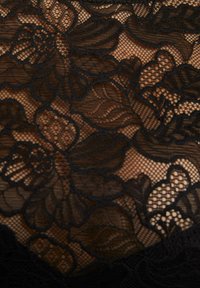 Tessuto in pizzo floreale nero caratterizzato da intricati motivi di fiori e foglie, con uno sfondo a rete delicato e una texture morbida.