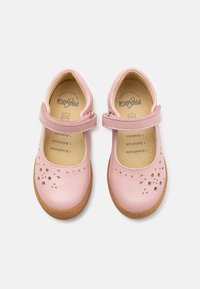 Zapatos Mary Jane de cuero rosa con punta redonda, diseño perforado en la parte superior y suela de goma. Correa ajustable con detalle de hebilla.