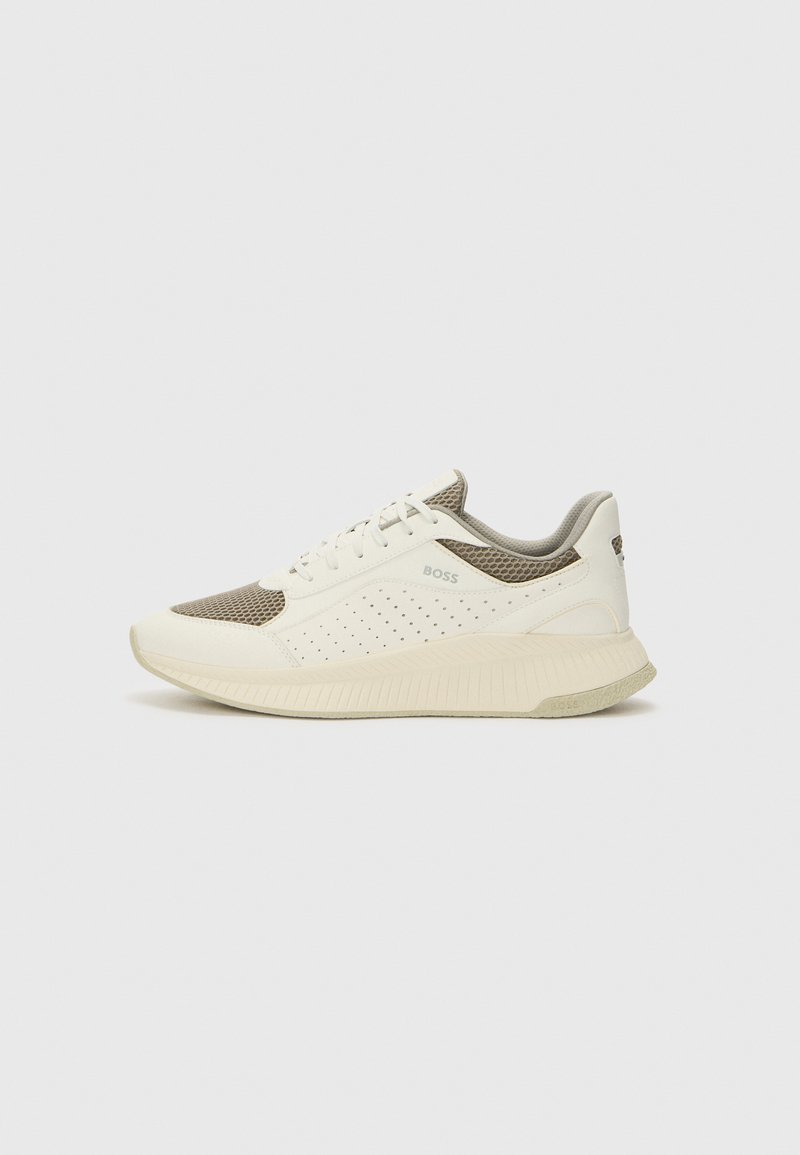 White and light beige athletic sneaker, featuring a mesh upper, perforated detailing, and a textured midsole with branding on the heel.