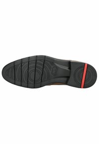 Schuhsohle mit einem geschwungenen Design, bestehend aus schwarzem Gummi mit strukturiertem Profil und einem roten Akzent an der Ferse.