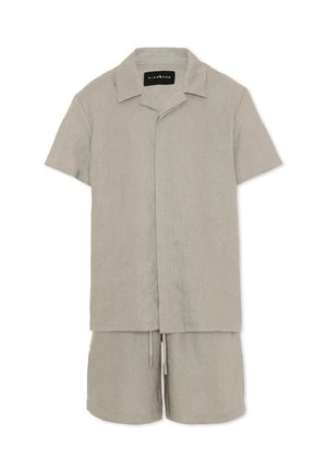 Chemise décontractée beige clair à manches courtes avec boutons, accompagnée d'un short à cordon assorti, fabriquée en tissu texturé.