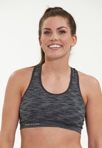 Musta ja harmaa urheiluliivi, jossa on racerback-malli. Teksturoitu kangas sisältää heather-muotoilun ja joustavan nauhan, jossa on "ENDURANCE"-logo.