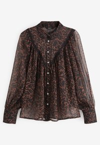 Blouse noire en voile transparent avec un motif abstrait marron. Elle présente une patte de boutonnage à l'avant, un col, et des manches longues bouffantes avec des poignets élastiques. Tissu texturé.