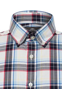 Camicia a quadri con linee rosse, blu e gialle su uno sfondo bianco. Colletto con bottoni e bottoni simili a perle. Tessuto in cotone.