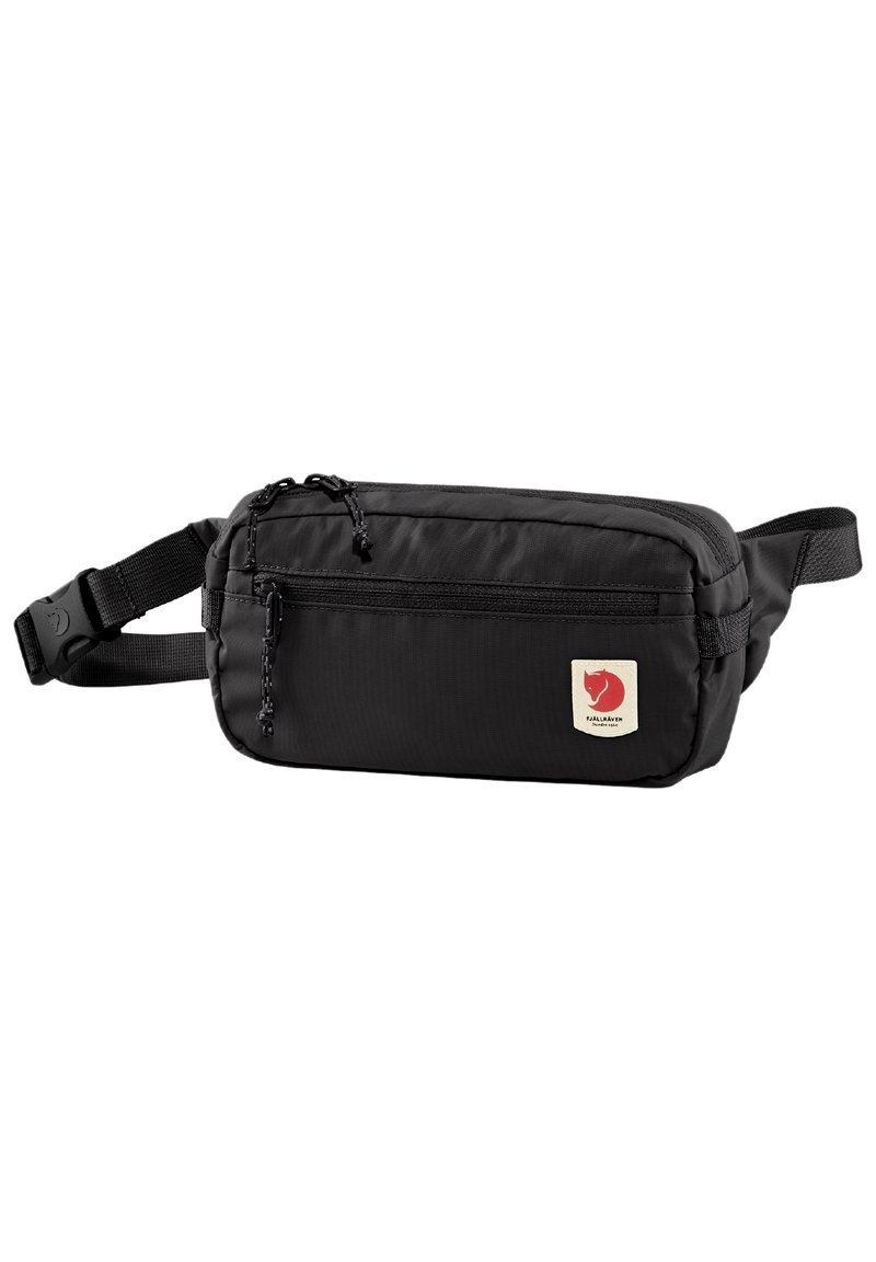 Black nylon fanny pack featuring a front zip pocket, adjustable strap, and a small logo patch with a red emblem. Smooth texture and compact design.