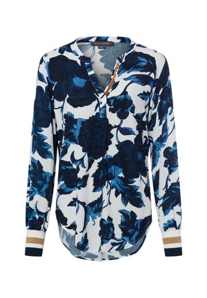 Floral blouse featuring a navy blue and white design, long sleeves, a v-neck, and ribbed cuffs with accents of gold and navy.