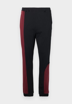 Μαύρο παντελόνι jogging με burgundy πλαϊνές φάσες, ελαστική μέση και μανσέτες. Κατασκευασμένο από μαλακό, ελαστικό υλικό για άνεση.