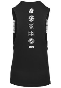 Zwarte mouwloze tanktop van katoen. Bevat witte graphics, waaronder een gorilla, logo's en het nummer "82" op de achterkant.