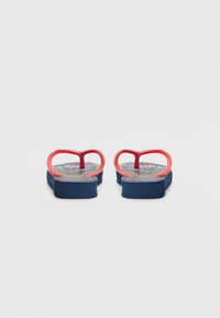 Red plastic flip-flops with heart-shaped straps, blue footbed featuring a multicolored graphic pattern, lightweight and flat sole.