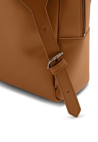 Brown leather backpack with a sleek design. Features a silver zipper and a sturdy adjustable strap with a metal buckle.