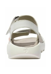 White sandal featuring a smooth leather upper with adjustable straps and a cushioned footbed. Closed back with a textured rubber sole.