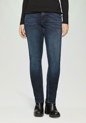 Donkerblauwe skinny jeans met een gladde denim textuur, een klassieke vijf-pocketstijl en subtiele vervaging aan de voorkant.