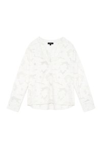Blouse blanche à manches longues avec un motif jacquard floral subtil, décolleté rond avec une petite découpe en V, et poignets à boutons.
